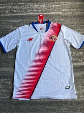 New Balance Kids CostaRica White Jersey with Red Diagonal Stripe and Blue Trim